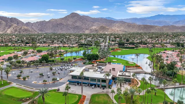 a view of a house with a garden and trees