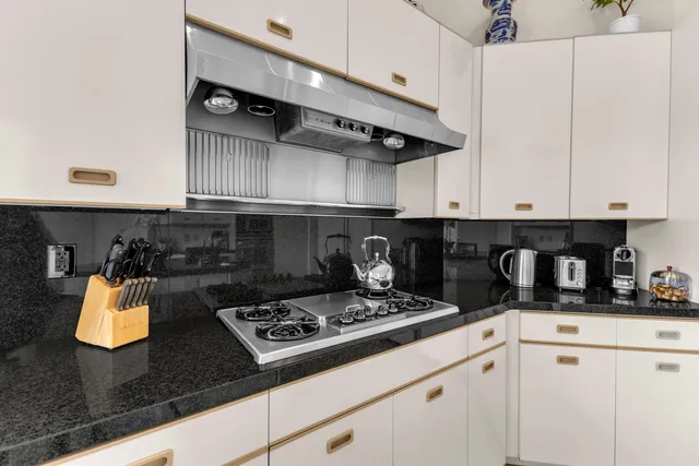 a bedroom with a bed and a flat tv screen on dresser