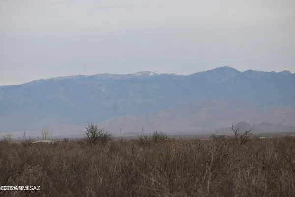 a view of a house with a mountain in the background