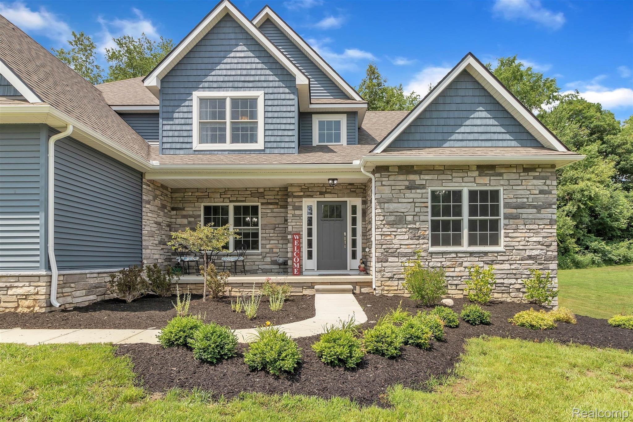 860 North Hacker Road Howell, MI 48843 - Photo 1 of 53 Sidewalks and Covered Porch Welcome Guests