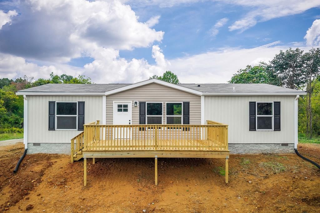9107 Barnes Ridge Road Monroe, TN 38573 - Photo 1 of 30 a front view of a house with garden