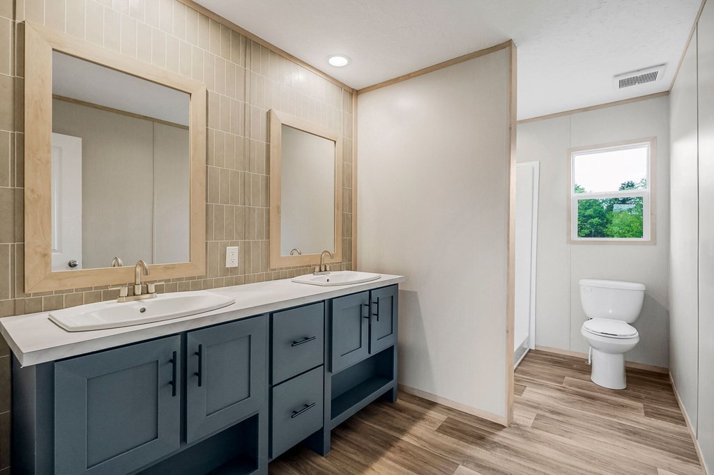 9107 Barnes Ridge Road Monroe, TN 38573 - Photo 12 of 30 a bathroom with a double vanity sink and a mirror