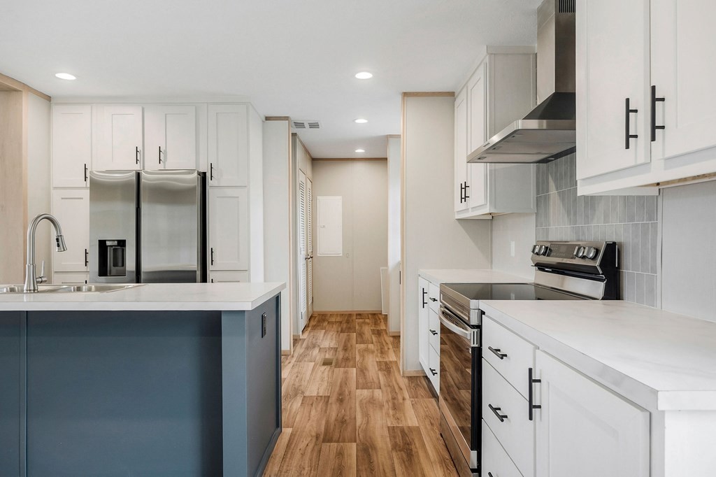 9107 Barnes Ridge Road Monroe, TN 38573 - Photo 13 of 30 a kitchen with stainless steel appliances a sink stove refrigerator and cabinets