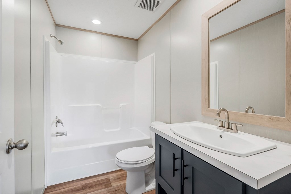 9107 Barnes Ridge Road Monroe, TN 38573 - Photo 19 of 30 a bathroom with a sink a toilet and shower