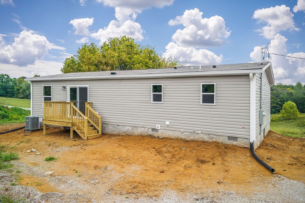 9107 Barnes Ridge Road Monroe, TN 38573 - Photo 25 of 30 a view of a house with a backyard