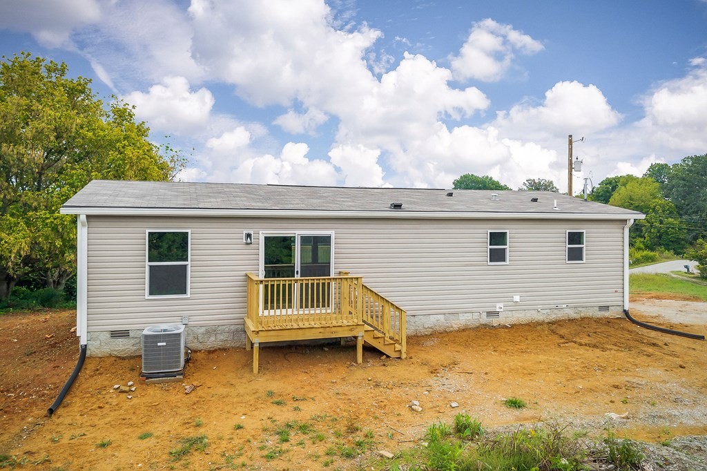 9107 Barnes Ridge Road Monroe, TN 38573 - Photo 26 of 30 a view of a house with a backyard and a tub