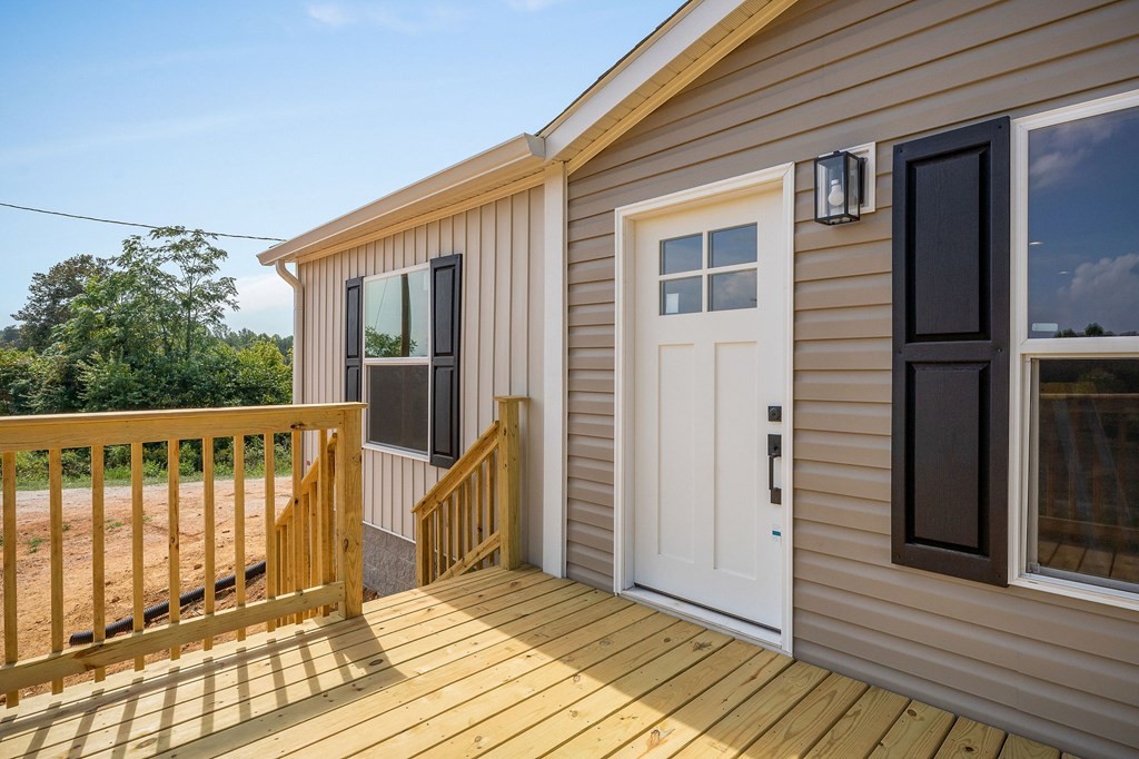 9107 Barnes Ridge Road Monroe, TN 38573 - Photo 3 of 30 a view of a deck with wooden floor and fence