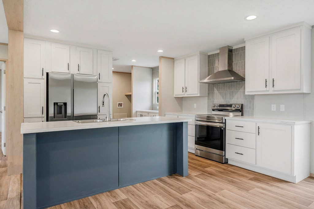 9107 Barnes Ridge Road Monroe, TN 38573 - Photo 8 of 30 a kitchen with stainless steel appliances granite countertop a sink stove and refrigerator