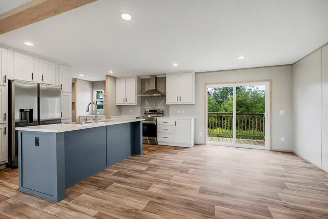 a kitchen with stainless steel appliances granite countertop a refrigerator sink and cabinets