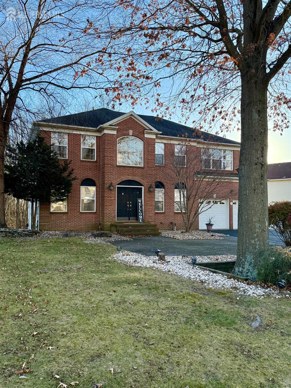 a front view of a house with a yard