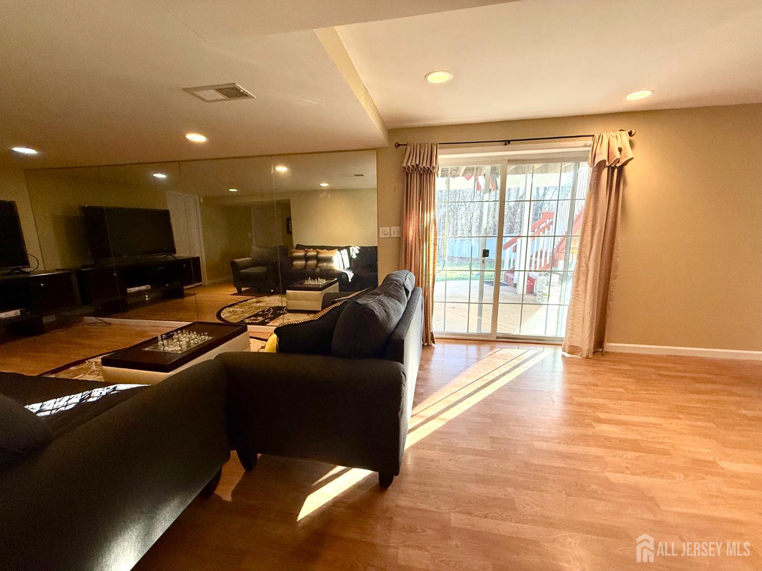 127 Disbrow Road Old Bridge, NJ 07747 - Photo 20 of 50 a living room with furniture and a flat screen tv
