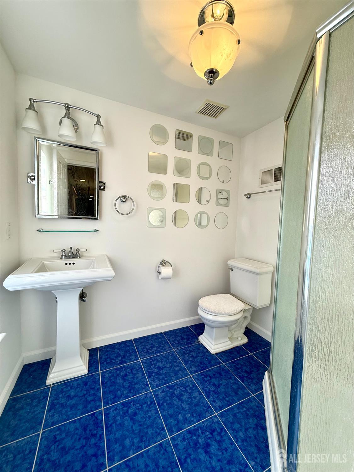 127 Disbrow Road Old Bridge, NJ 07747 - Photo 23 of 50 a bathroom with a sink toilet a mirror and shower