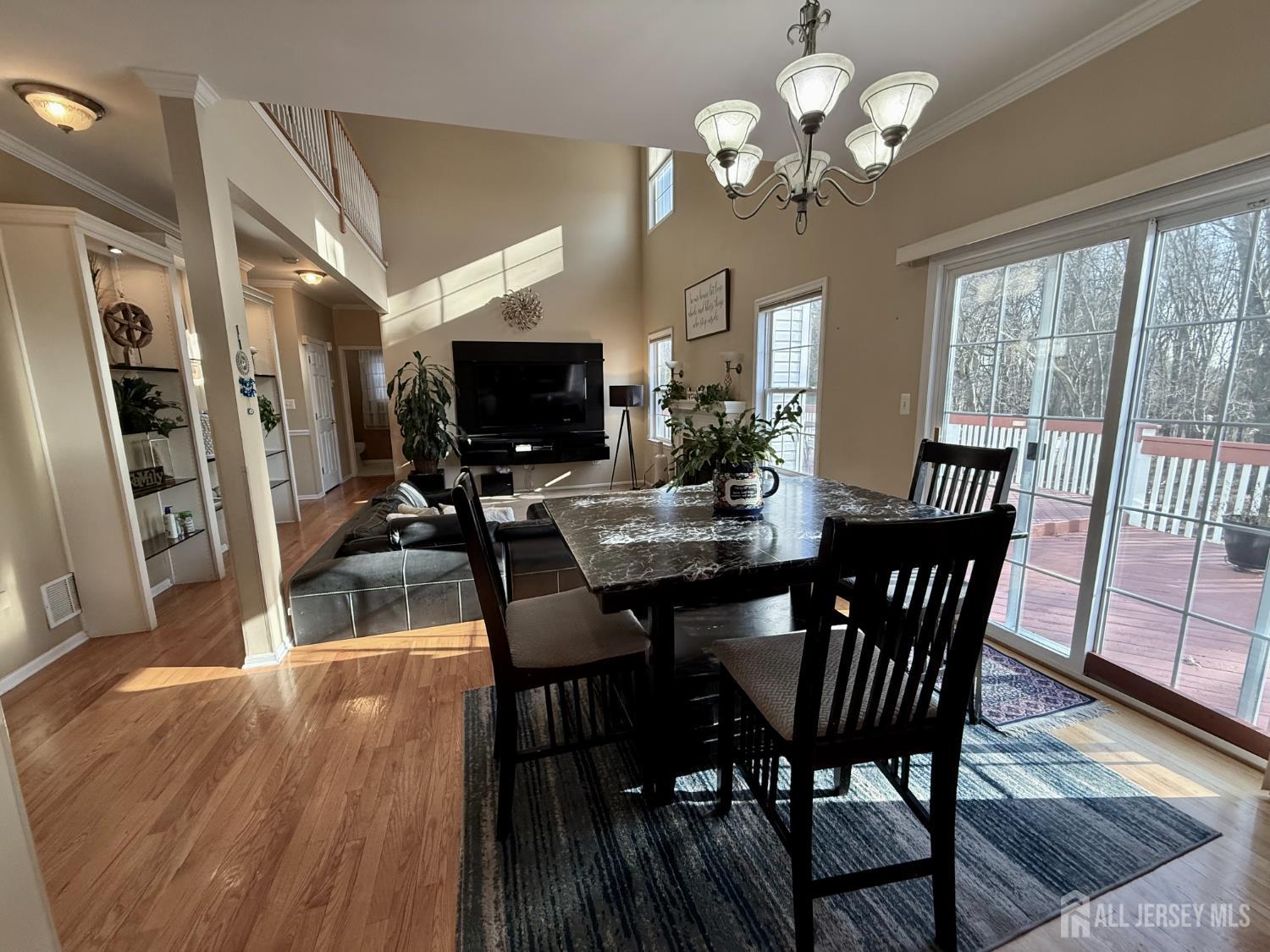 127 Disbrow Road Old Bridge, NJ 07747 - Photo 34 of 50 a view of a dining room with furniture a chandelier and wooden floor
