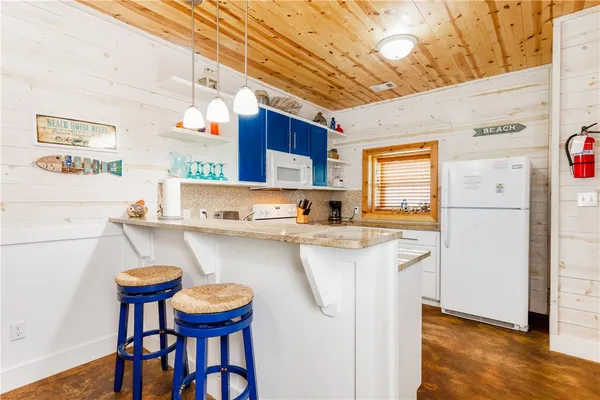 a kitchen with stainless steel appliances granite countertop a sink a stove and cabinets