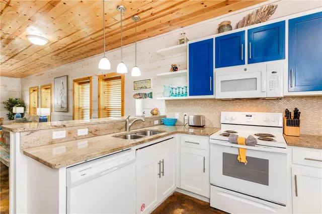 a white refrigerator freezer sitting inside of a kitchen