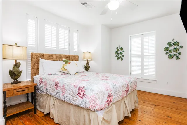 a bedroom with a bed a flat tv and a window