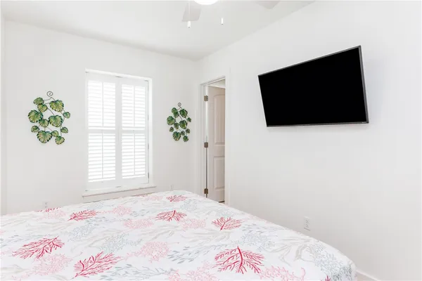 a bedroom with a bed and a flat screen tv