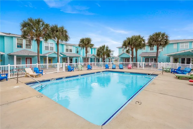 a view of a swimming pool with outdoor seating