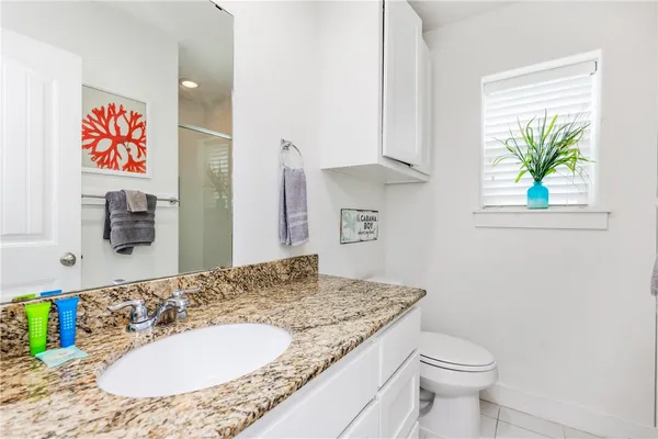 a swimming pool view with a seating space and a garden view