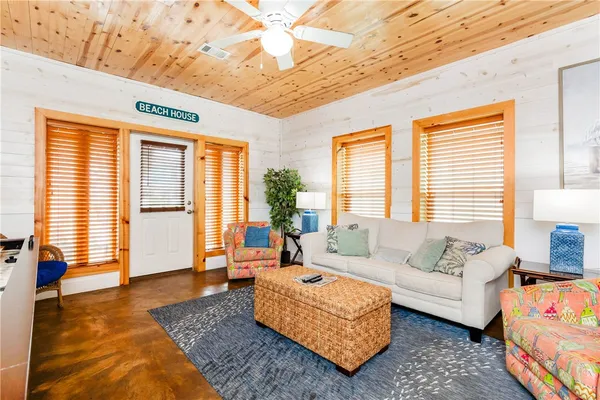 a living room with furniture rug and wooden floor