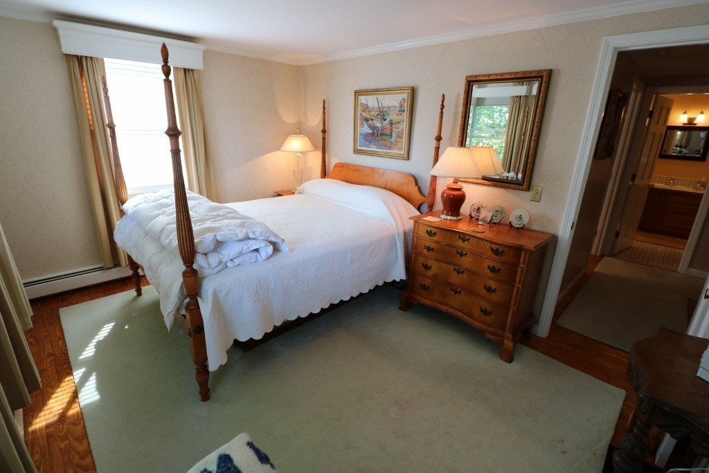5 Highview Road Rockport, MA 01966 - Photo 9 of 15 a bedroom with a bed and a flat tv screen on dresser