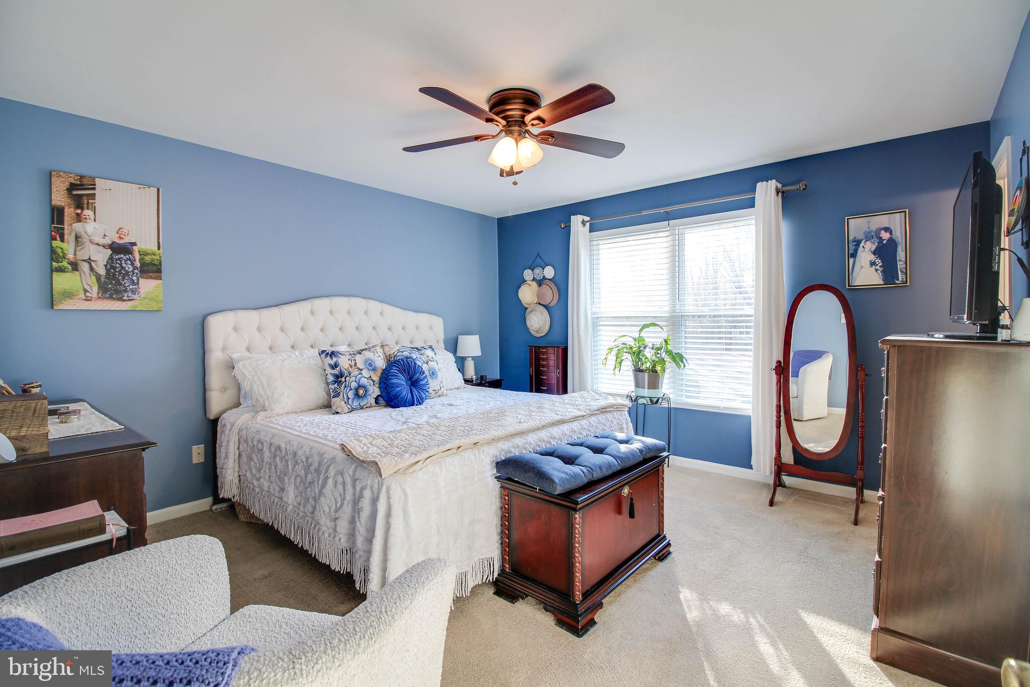 8000 Solley Road Glen Burnie, MD 21060 - Photo 14 of 44 a bedroom with a bed and a chandelier