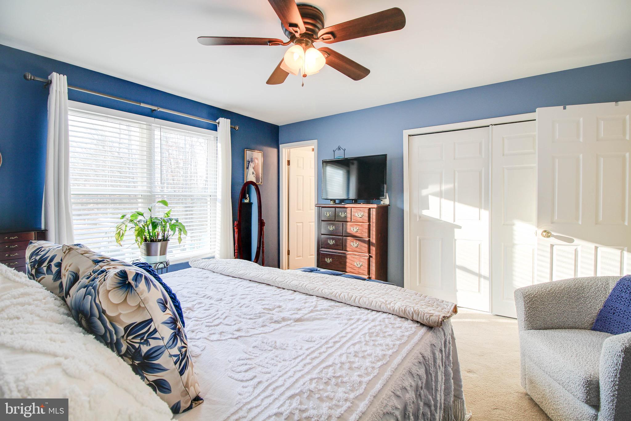 8000 Solley Road Glen Burnie, MD 21060 - Photo 16 of 44 a bedroom with a large bed and a chandelier