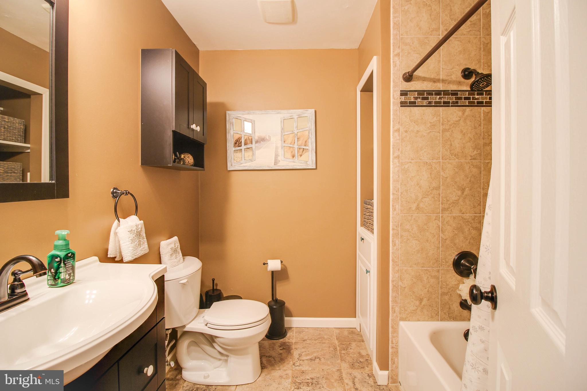 8000 Solley Road Glen Burnie, MD 21060 - Photo 18 of 44 a white toilet sitting next to a bathroom sink