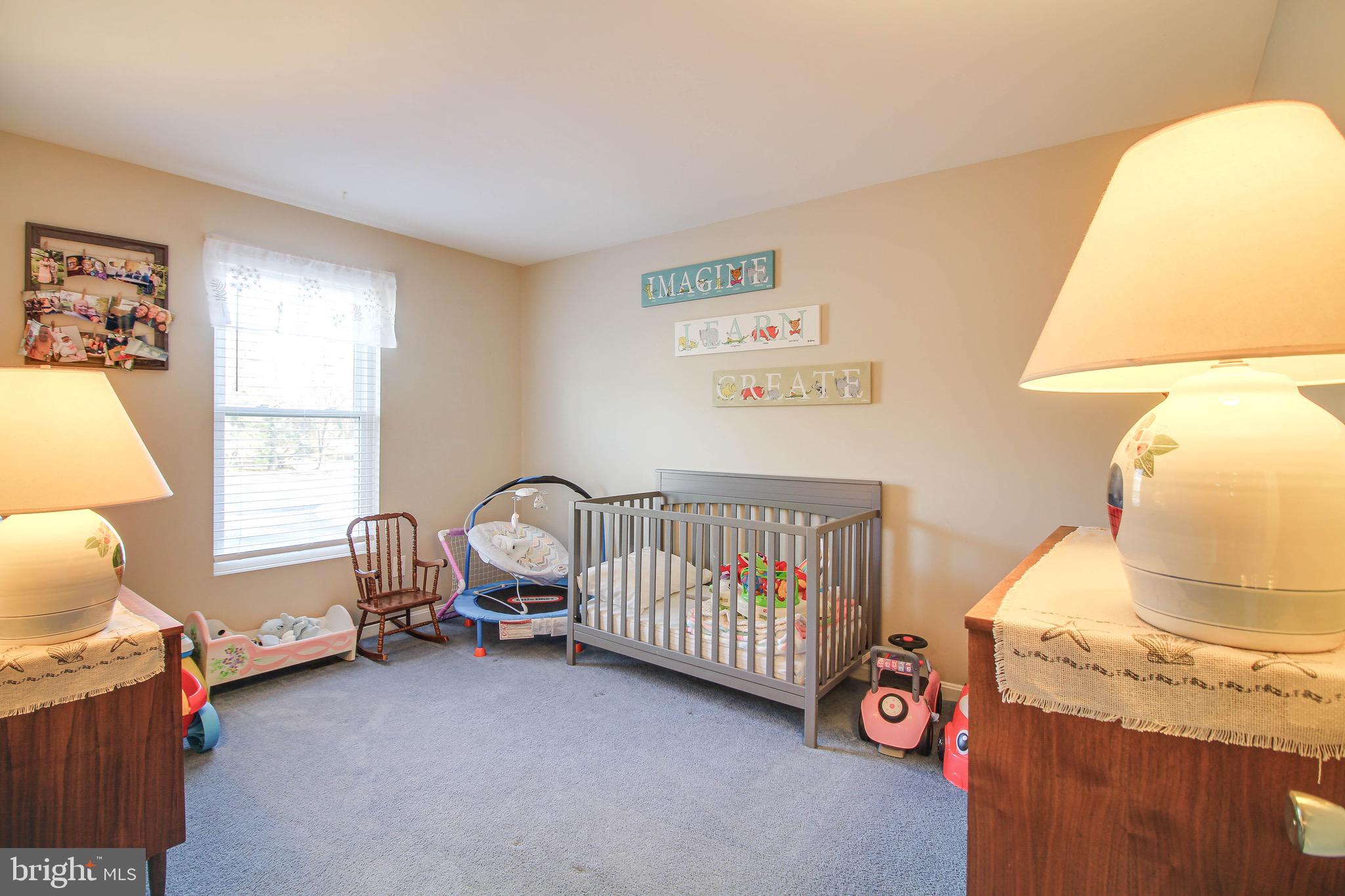 8000 Solley Road Glen Burnie, MD 21060 - Photo 19 of 44 a bedroom with a baby bed a couch and a window