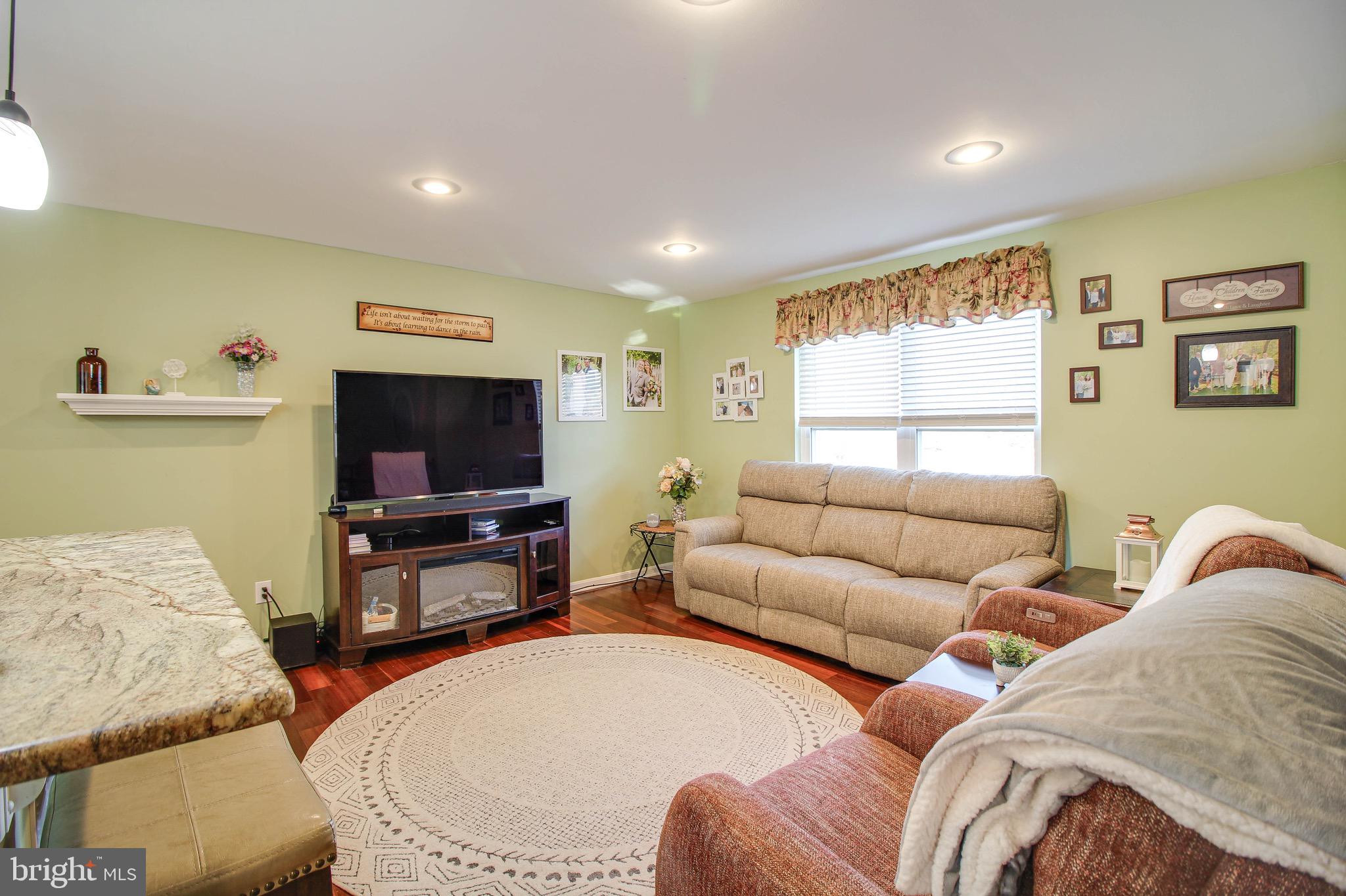 8000 Solley Road Glen Burnie, MD 21060 - Photo 3 of 44 a living room with furniture and a flat screen tv