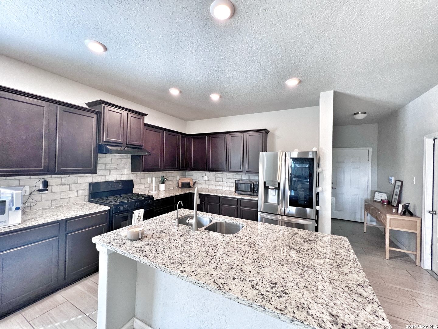 1224 Loma Ranch New Braunfels, TX 78132 - Photo 13 of 29 a kitchen with a sink a counter top stainless steel appliances and cabinets
