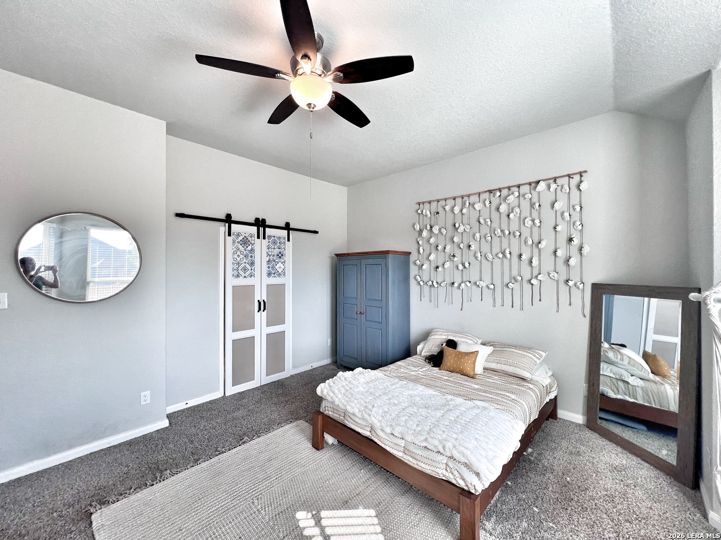 1224 Loma Ranch New Braunfels, TX 78132 - Photo 4 of 29 a bedroom with a large bed and a chandelier
