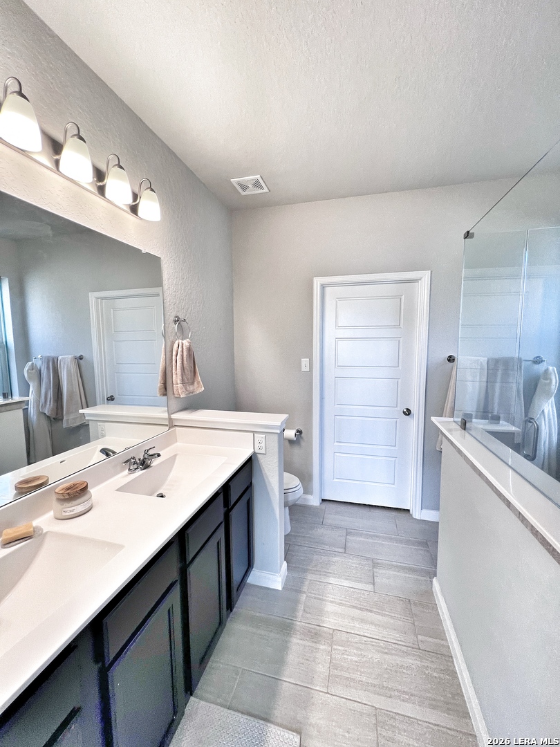 1224 Loma Ranch New Braunfels, TX 78132 - Photo 5 of 29 a bathroom with a sink double vanity granite tub and a mirror