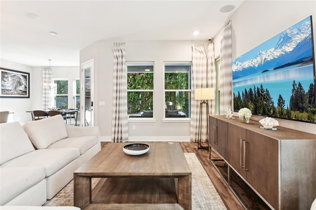 6054 Bimini Twist Loop Orlando, FL 32819 - Photo 11 of 76 a living room with furniture and a large window