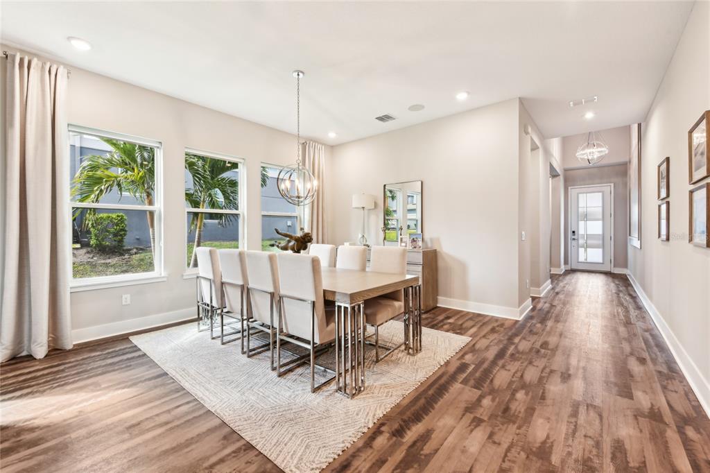 6054 Bimini Twist Loop Orlando, FL 32819 - Photo 16 of 76 a view of a dining room with furniture window and wooden floor