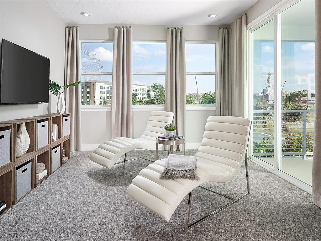 6054 Bimini Twist Loop Orlando, FL 32819 - Photo 4 of 76 a living room with furniture a flat screen tv and a floor to ceiling window