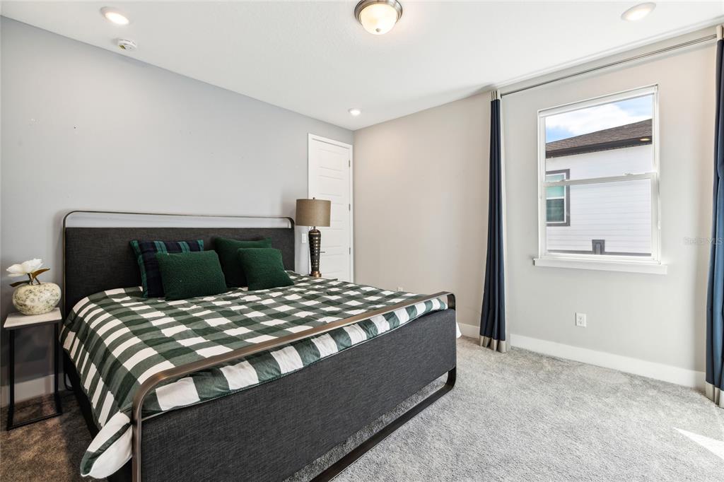 6054 Bimini Twist Loop Orlando, FL 32819 - Photo 50 of 76 a bedroom with a bed and a mirror