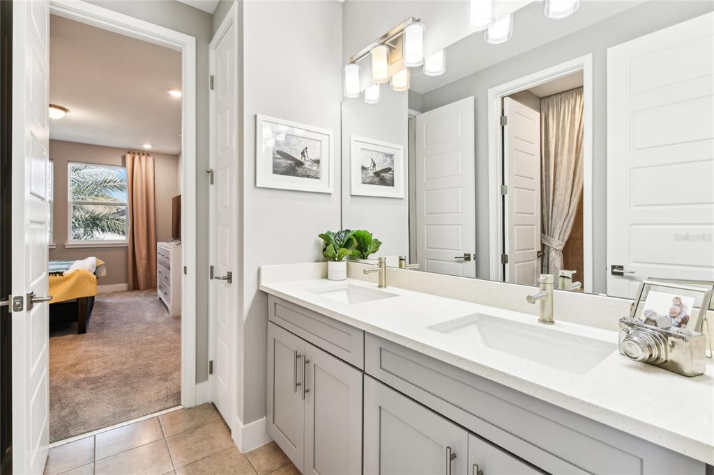 6054 Bimini Twist Loop Orlando, FL 32819 - Photo 52 of 76 a bathroom with a sink double vanity and a mirror