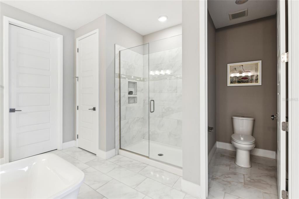6054 Bimini Twist Loop Orlando, FL 32819 - Photo 64 of 76 a bathroom with a shower and a toilet