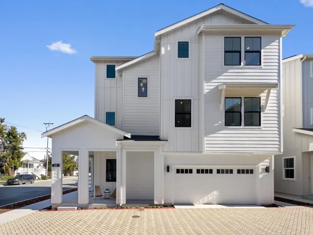 a front view of residential houses with buildings