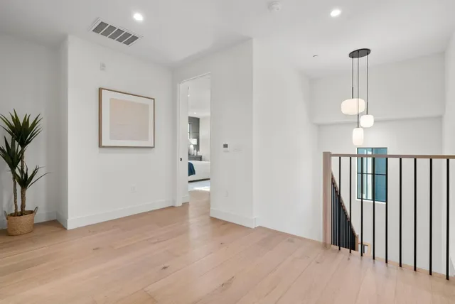 a bedroom with a bed and a painting on the wall