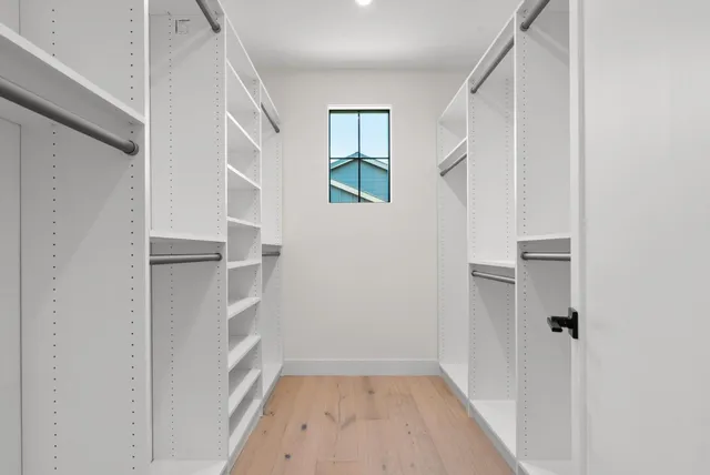 a kitchen with stainless steel appliances a dining table chairs and a refrigerator