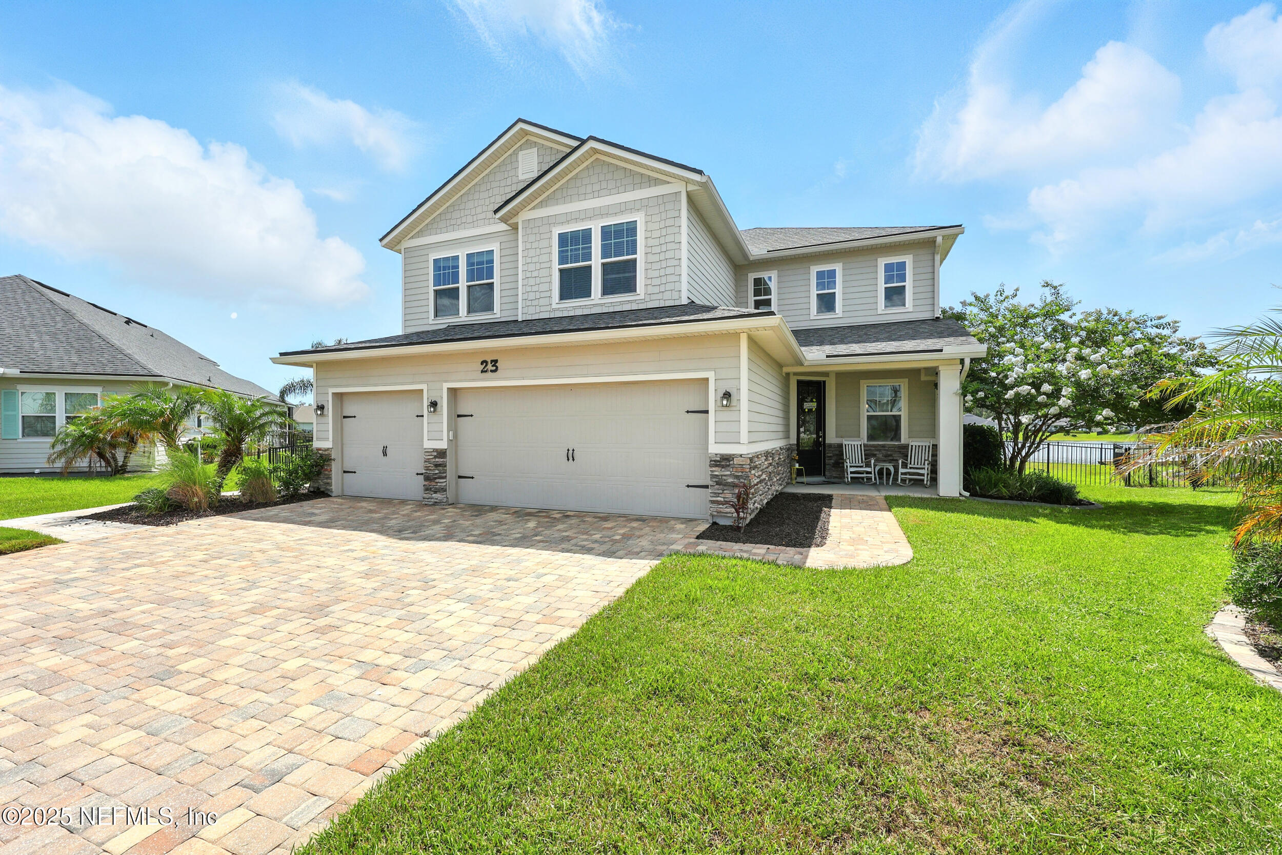 a view of a house with a yard and sitting area
