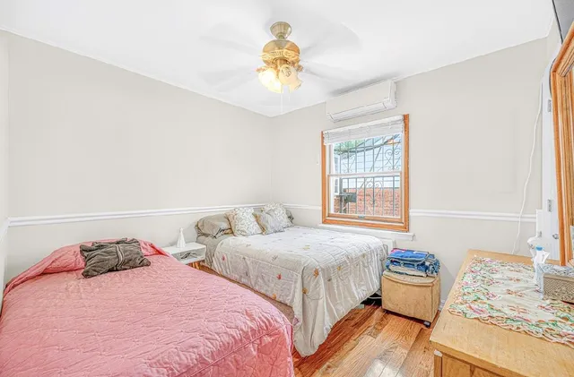 a bedroom with two beds and a window