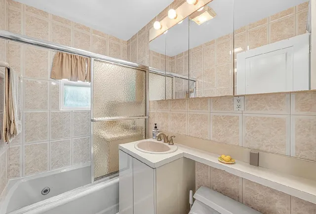 a bathroom with a sink a mirror and a bathtub