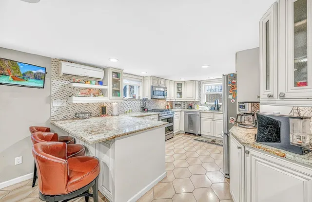 a kitchen with stainless steel appliances granite countertop a sink and cabinets