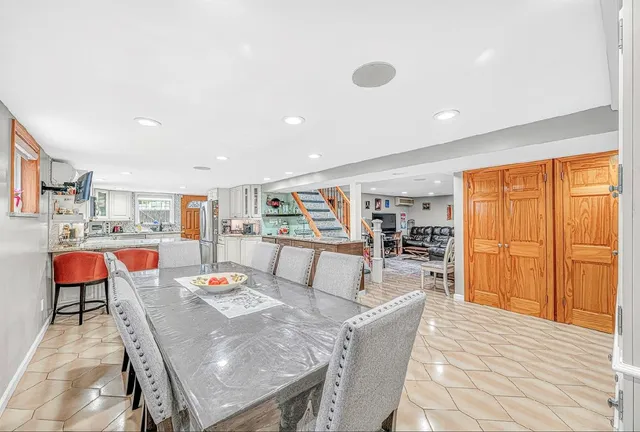 a living room with furniture a rug and a large window
