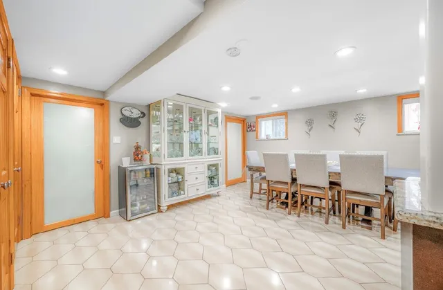 a living room with furniture a dining table and chairs with wooden floor