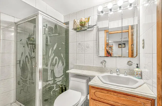 a bathroom with a sink toilet and shower