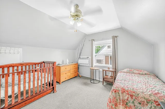 a bedroom with furniture and a window